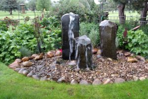 A custom column water feature in a Boise home garden installed by FarWest Landscape.